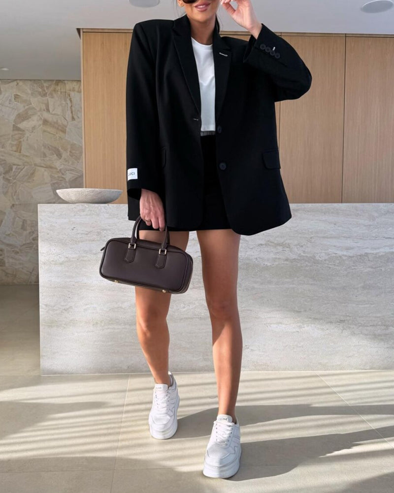 Modern elegant outfit with blazer and two-piece shorts