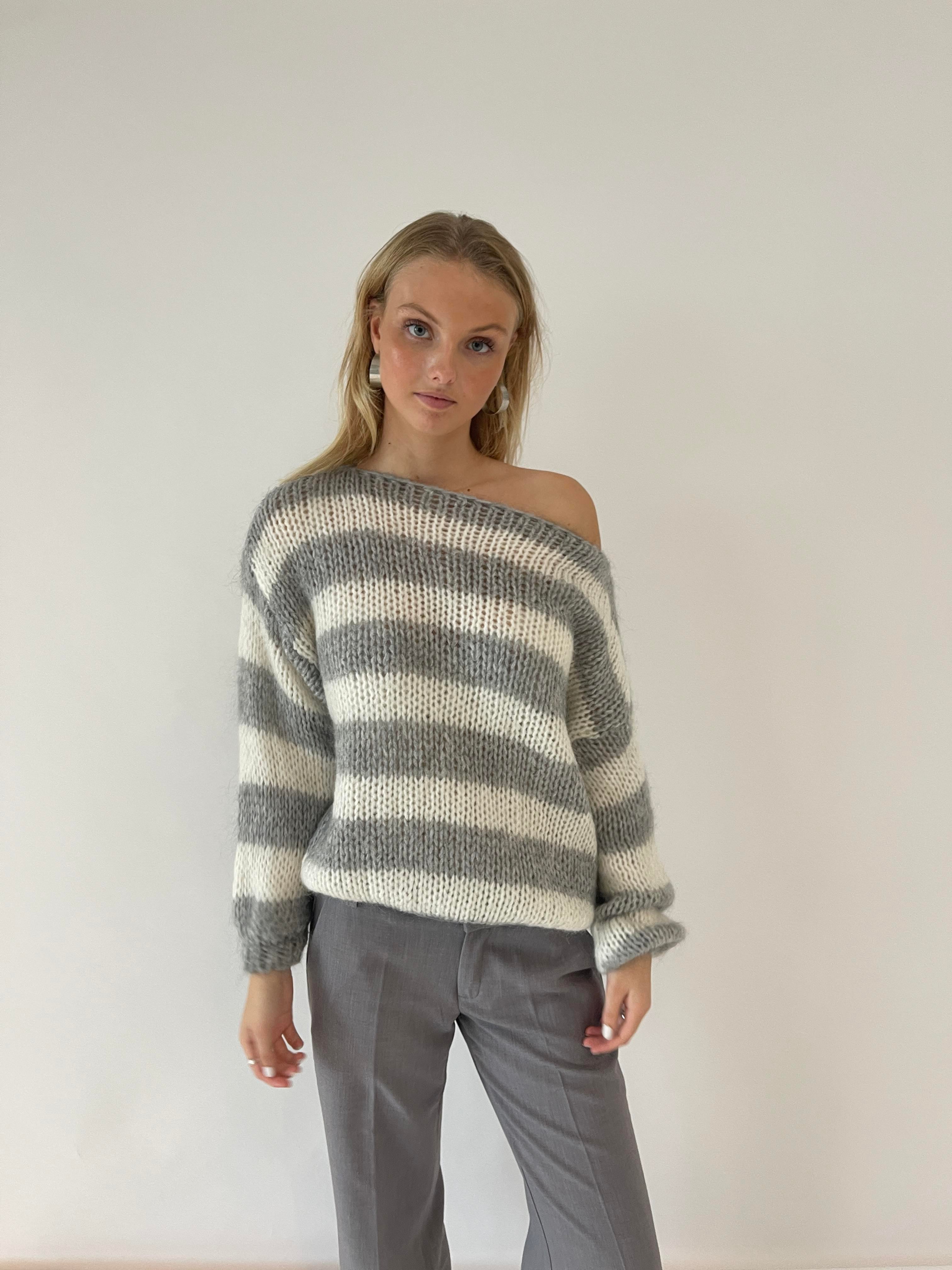 Elegant women's knitted sweater with a stylish striped pattern