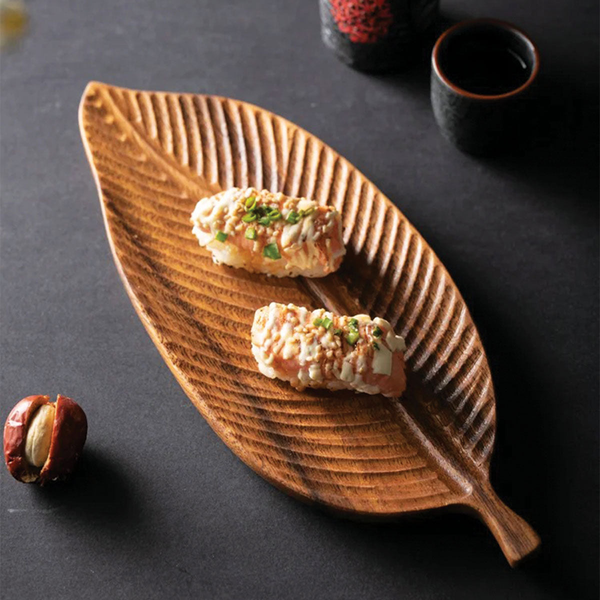 Bowl made of dark walnut wood with leaves