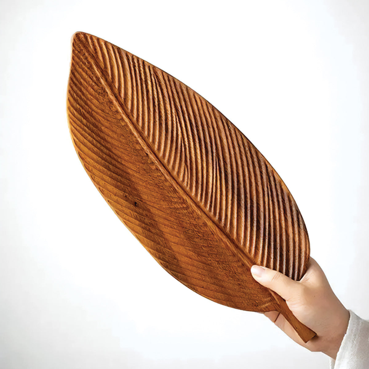 Bowl made of dark walnut wood with leaves