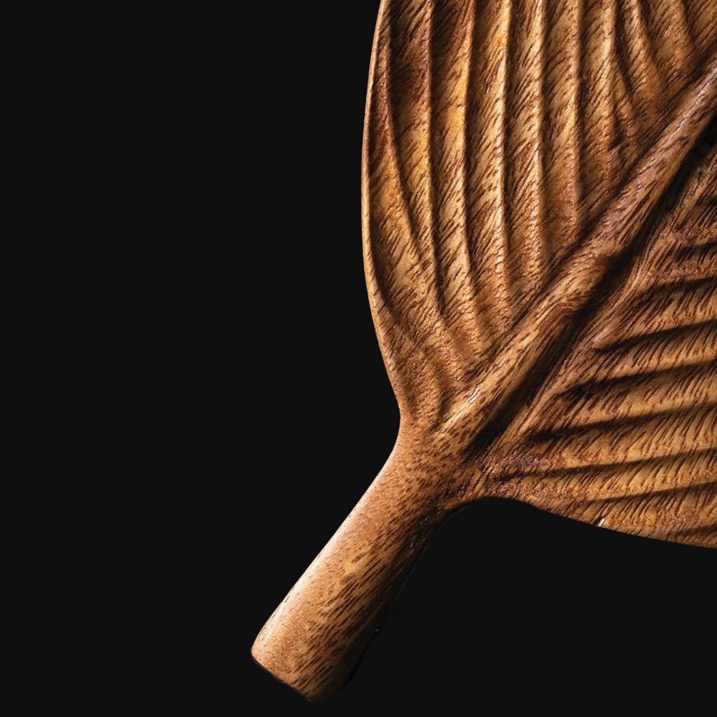 Bowl made of dark walnut wood with leaves