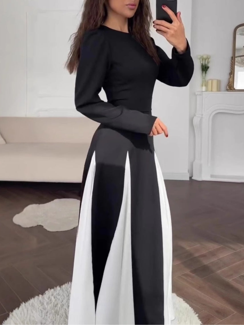 Elegant long-sleeve dress with a round neck and colorblock design in black and white